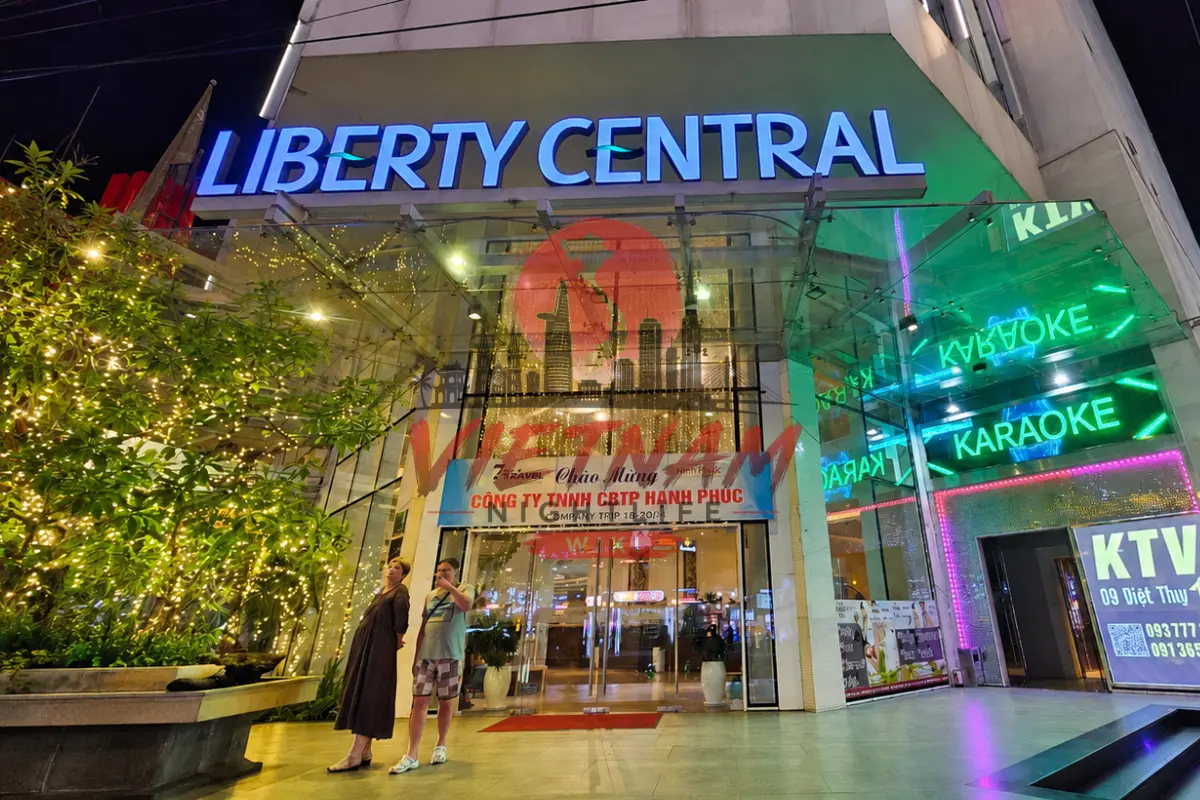 나트랑 리버티 가라오케 7 Biệt Thự 비엣투 여행자 거리 야간 빌딩 외관 — LIBERTY CENTRAL 블루 LED 간판과 KARAOKE 그린 네온 게이트